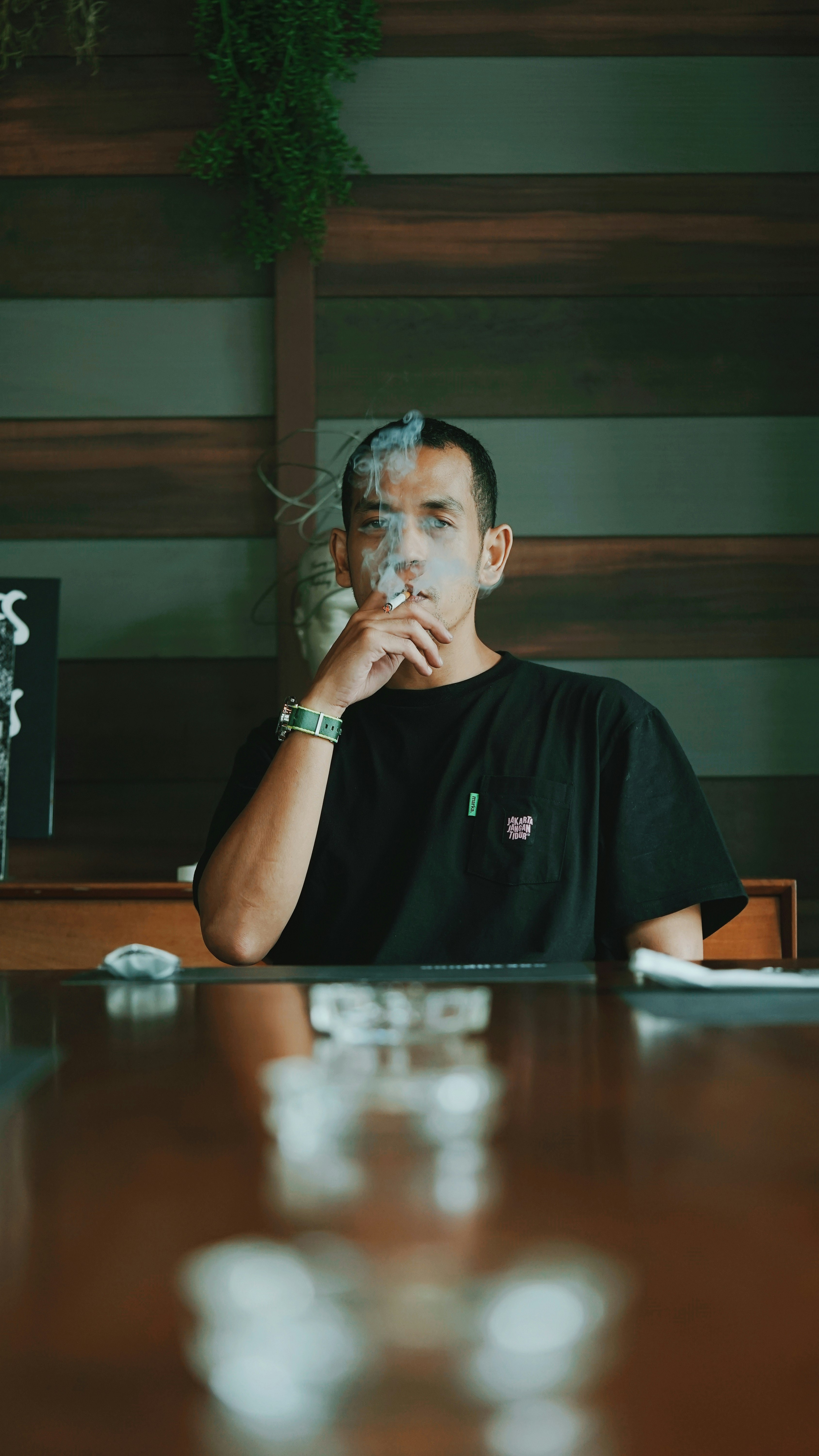 man in black crew neck t-shirt sitting on chair